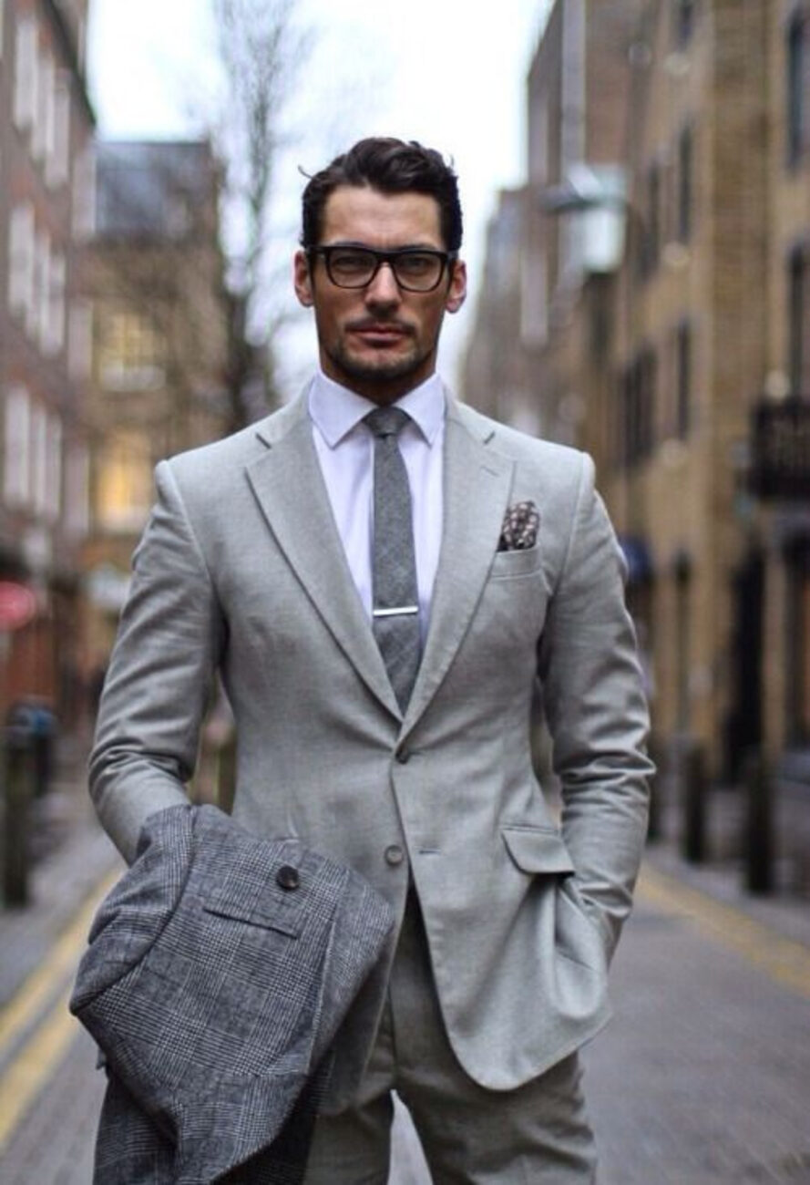 Master tailor fitting a grey bespoke suit in the Paul Bespoke Bangkok atelier